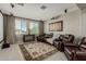 Relax in this living room featuring comfortable leather seating and a projector with a screen at 9747 W Sands Dr, Peoria, AZ 85383