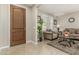 Elegant living room featuring neutral tones, tile flooring, and stylish furniture at 9747 W Sands Dr, Peoria, AZ 85383