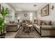 Comfortable living room showcasing tile floors, an area rug, and a plant at 9747 W Sands Dr, Peoria, AZ 85383