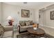 Comfortable living room showcasing tile floors, an area rug, and a plant at 9747 W Sands Dr, Peoria, AZ 85383