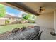 Covered patio with view of backyard and a dining table at 9747 W Sands Dr, Peoria, AZ 85383