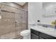 Bathroom featuring a tiled shower with glass doors, white toilet and sink vanity offering style and functionality at 1018 S Toltec --, Mesa, AZ 85204