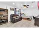 A bedroom with tile flooring, a leather couch, and a wooden bed frame, offering a relaxing space at 1018 S Toltec --, Mesa, AZ 85204