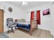 Bedroom with a wooden bed frame, tile floors, mounted TV, and red curtains at 1018 S Toltec --, Mesa, AZ 85204