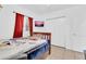 A bedroom with tiled floors, a wooden bed frame, and a window, offering a bright and cozy living space at 1018 S Toltec --, Mesa, AZ 85204