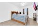Bedroom featuring a wooden bed frame, tile floors, mounted TV, and shelving at 1018 S Toltec --, Mesa, AZ 85204