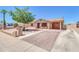Charming single story home featuring a brick paved driveway, covered parking, and a cozy front porch seating area at 1018 S Toltec --, Mesa, AZ 85204