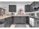 A kitchen with black cabinets and countertops, providing ample space for cooking and storage at 1018 S Toltec --, Mesa, AZ 85204