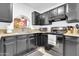 Kitchen with black cabinetry, granite countertops, tile backsplash, and modern appliances at 1018 S Toltec --, Mesa, AZ 85204