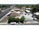 Aerial view of buildings, parking, and surrounding houses and street at 1039 E Broadway Rd, Mesa, AZ 85204
