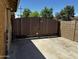 Backyard gate and partial exterior view with a concrete area, providing secure access at 1039 E Broadway Rd, Mesa, AZ 85204