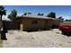 Exterior of home with brick-paved backyard, fence and red truck at 1039 E Broadway Rd, Mesa, AZ 85204