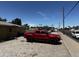 Exterior of property showing brick pavers, trash bins and a red truck at 1039 E Broadway Rd, Mesa, AZ 85204