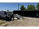 View of property's exterior showing yard debris at 1039 E Broadway Rd, Mesa, AZ 85204