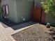 View of the entrance gate and brick sidewalk leading to the front door, surrounded by lush greenery at 1039 E Broadway Rd, Mesa, AZ 85204