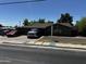 Front exterior showcasing well-maintained landscaping, a brick sidewalk, and ample parking at 1039 E Broadway Rd, Mesa, AZ 85204