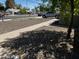 Home with manicured front yard with rock landscape and brick sidewalk at 1039 E Broadway Rd, Mesa, AZ 85204