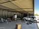Interior garage view, showcasing tools and a partially disassembled white car at 1039 E Broadway Rd, Mesa, AZ 85204