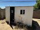Close-up of the shed featuring a window and door that offer ample room for storage at 1039 E Broadway Rd, Mesa, AZ 85204