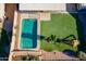 Aerial view of a backyard featuring a pool, artificial turf, and a play structure at 10822 W Quail Ave, Peoria, AZ 85373