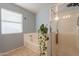 Bright bathroom featuring a soaking tub, walk-in shower, and a large window at 10822 W Quail Ave, Peoria, AZ 85373