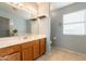 The bathroom features a traditional vanity with a framed mirror, vanity lights and tile flooring at 10822 W Quail Ave, Peoria, AZ 85373