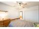 Neutrally painted bedroom featuring a ceiling fan and double door closet at 10822 W Quail Ave, Peoria, AZ 85373