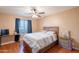 Cozy bedroom featuring wood-look floors, ceiling fan, and natural light at 10822 W Quail Ave, Peoria, AZ 85373