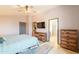 This bedroom offers a large closet, neutral colors, an entertainment center, and outside access at 10822 W Quail Ave, Peoria, AZ 85373