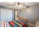 Bedroom with light grey walls, ceiling fan, and a double door closet at 10822 W Quail Ave, Peoria, AZ 85373