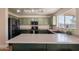 Kitchen with large island, stainless steel appliances and bright lighting at 10822 W Quail Ave, Peoria, AZ 85373