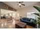 Inviting living room featuring vaulted ceilings, a ceiling fan, and wood-look flooring at 10822 W Quail Ave, Peoria, AZ 85373