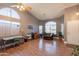 Bright living room with hardwood floors, large windows, and a comfortable seating area at 10822 W Quail Ave, Peoria, AZ 85373