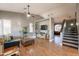 Spacious living room featuring hardwood floors, a comfortable sofa, and access to the stairway at 10822 W Quail Ave, Peoria, AZ 85373