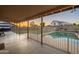Covered patio with pool view, gated for safety, and ample space for outdoor seating at 10822 W Quail Ave, Peoria, AZ 85373
