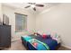 bedroom featuring two beds with cartoon themed bedding and a dark wooden dresser at 13123 W Cottontail Ln, Peoria, AZ 85383