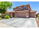 Expansive home with a wide driveway, three-car garage, and a well-maintained lawn creates a striking curb appeal at 13123 W Cottontail Ln, Peoria, AZ 85383