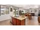 Open-concept kitchen flows into dining and living areas, featuring a granite island and stainless steel dishwasher at 13123 W Cottontail Ln, Peoria, AZ 85383