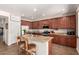 Spacious kitchen with granite countertops, stainless steel appliances, and a large island with seating at 13123 W Cottontail Ln, Peoria, AZ 85383