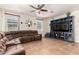 Cozy living room featuring a comfortable sectional, stylish entertainment center, and plenty of natural light at 13123 W Cottontail Ln, Peoria, AZ 85383