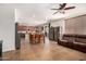Open-concept living area with a kitchen, dining table, and cozy living room space offering a bright and airy atmosphere at 13123 W Cottontail Ln, Peoria, AZ 85383