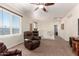 Upstairs loft area with a comfortable armchair, natural light, and plush carpeting, creating a cozy and versatile space at 13123 W Cottontail Ln, Peoria, AZ 85383