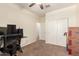 Study with rolling chair, a computer on a desk, and two large closet doors at 13123 W Cottontail Ln, Peoria, AZ 85383