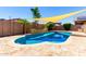Backyard pool with a sunshade, rock waterfall feature, pergola, and lush landscaping at 13123 W Cottontail Ln, Peoria, AZ 85383
