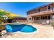 Backyard pool with safety fence and patio outside of the two-story home at 13123 W Cottontail Ln, Peoria, AZ 85383
