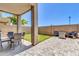 The cozy covered patio overlooks artificial turf and is perfect for outdoor dining and relaxation at 1350 S Greenfield Rd # 1166, Mesa, AZ 85206