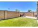 Spacious backyard with artificial turf, stone pavers, grill and patio seating offers a serene outdoor escape at 1350 S Greenfield Rd # 1166, Mesa, AZ 85206