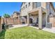The backyard oasis features a built-in grill, covered patio, and a green artificial turf area at 1350 S Greenfield Rd # 1166, Mesa, AZ 85206