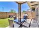 Outdoor patio with dining table, chairs, BBQ, and artificial turf in the fenced-in backyard at 1350 S Greenfield Rd # 1166, Mesa, AZ 85206