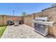 A stone-paved backyard features a built-in grill and an inviting seating area to enjoy outdoor living at 1350 S Greenfield Rd # 1166, Mesa, AZ 85206